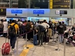 Travelers wait in queues at IndiGo ticketing kiosks at Kempegowda International Airport in Bengaluru.