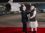 Prime Minister Narendra Modi, right, welcomes Russian President Vladimir Putin at Palam Air Base in New Delhi