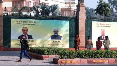 People walk past a hoarding installed outside Hyderabad House to welcome Russia's President Vladimir Putin to India on his visit, in New Delhi on Thursday. (ANI Photo) (Sathiya) People walk past a hoarding installed outside Hyderabad House to welcome Russia's President Vladimir Putin to India on his visit, in New Delhi on Thursday. (ANI Photo) (Sathiya)