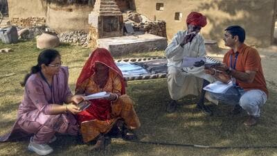 Booth Level Officers assist voters in filing enumeration forms for the Special Intensive Revision of electoral rolls in Bikaner, Rajasthan. (PTI) Booth Level Officers assist voters in filing enumeration forms for the Special Intensive Revision of electoral rolls in Bikaner, Rajasthan. (PTI)