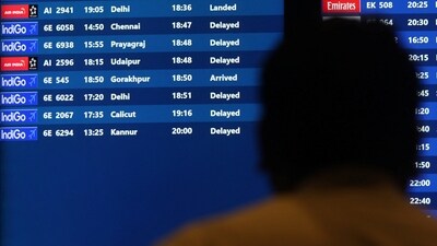 A man looks at a flight schedule screen displaying several delayed flights by IndiGo airlines at the Chhatrapati Shivaji Maharaj International Airport in Mumbai. (REUTERS)