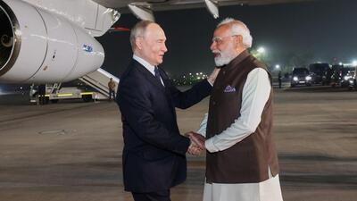 Modi greeted Putin as he emerged from his official aircraft and stepped onto the red carpet on a winter night . (AP)