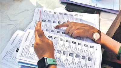 Thane, India - December -02, 2025: KulgaonÐBadlapur Municipal Council (nager Parishad)General Election 2025: In Badlapur, Thane district, voting for the KulgaonÐBadlapur Municipal Council (nager Parishad) has begun on Tuesday Voters searching name in Voter list at the polling stations at badalapur East ,in Thane ,in Mumbai, India, on, Tuesday, December -02, 2025. ( Praful Gangurde / HT Photo) (Praful Gangurde) Thane, India - December -02, 2025: KulgaonÐBadlapur Municipal Council (nager Parishad)General Election 2025: In Badlapur, Thane district, voting for the KulgaonÐBadlapur Municipal Council (nager Parishad) has begun on Tuesday Voters searching name in Voter list at the polling stations at badalapur East ,in Thane ,in Mumbai, India, on, Tuesday, December -02, 2025. ( Praful Gangurde / HT Photo) (Praful Gangurde)