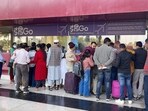 Flight passengers wait with their baggage as many IndiGo flight services stand cancelled at Agartala Airport, in Agartala on Friday. 