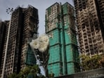 A flower bouquet is placed at the scene of the Wang Fuk Court housing complex fire, as mourners pay tribute to the victims, in Tai Po, Hong Kong, China.
