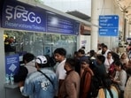 Passengers wait outside the IndiGo airlines ticketing counter at the Chhatrapati Shivaji Maharaj International Airport, after several IndiGo airlines flights were cancelled, in Mumbai, India, December 6, 2025. 