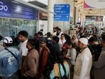 Passengers wait outside the IndiGo airlines ticketing counter at the Chhatrapati Shivaji Maharaj International Airport, after several IndiGo airlines flights were cancelled, in Mumbai, India, December 6, 2025. 