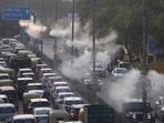 Commuters pass through Delhi’s new water spray system to fight the air pollution, in New Delhi on Saturday. Commuters pass through Delhi’s new water spray system to fight the air pollution, in New Delhi on Saturday.