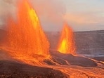 This image from webcam footage provided by the United States Geological Survey (USGS) shows lava fountains shooting up in the air in the latest episode of an ongoing eruption of Kilauea volcano.
