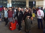 Stranded passengers wait at Jaiprakash Narayan Airport in Patna amid widespread Indigo flights disruptions.