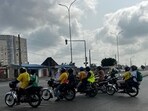 Motorbike taxis carrying passengers stops at a crossroad in Cotonou following rumors of a possible coup in the country on December 7, 2025. Benin's President Patrice Talon is safe and the army is regaining control, after a group of soldiers said they had ousted him from power, the presidency told AFP on Sunday.
"This is a small group of people who only control the television," his office said. "The regular army is regaining control. The city and the country are completely secure." (Photo by AFP)