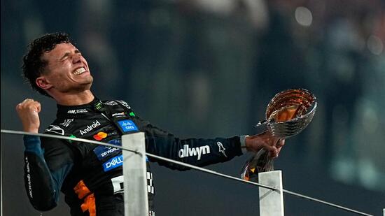 McLaren driver Lando Norris celebrates after becoming a world champion after the F1 Abu Dhabi Grand Prix at the Yas Marina Circuit in Abu Dhabi. (AP)