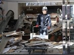 Japan earthquake today live: A worker clears debris at a shopping center damaged by the earthquake in Hachinohe City, Aomori Prefecture on December 9, 2025.
