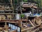 An excavator demolishes wooden structures at Romeo Lane on Anjuna beach after a fire at the adjacent Birch by Romeo Lane nightclub killed 25 people.