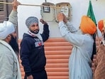 Farmer union members removing smart meters in Sasrali village, Ludhiana, on Wednesday. (HT Photo)