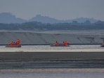 National Disaster Response Force conducts search operations for missing persons who were washed away while bathing in the Brahmaputra river at Kharghuli in Guwahati, on Dec 10. (PTI)