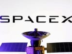 FILE PHOTO: SpaceX logo and miniature satellite model are seen in this illustration created on March 10, 2025. REUTERS/Dado Ruvic/Illustration/File Photo