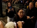 Nobel peace laureate Maria Corina Machado greets supporters gathered outside the Grand Hotel in Oslo, Norway, early on December 11, 2025. Machado arrived in Oslo hours after the Venezuelan opposition leader's award was collected on her behalf by her daughter. 