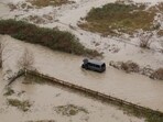 A drone view shows a vehicle stranded in an area flooded by the Wallace River, as an atmospheric river brings rain and flooding to the Pacific Northwest, in Gold Bar, Washington, U.S., December 10, 2025.  REUTERS/David Ryder