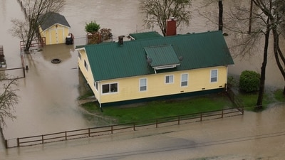 A drone view shows a home in an area flooded by the Wallace River, as an atmospheric river brings rain and flooding to the Pacific Northwest, in Gold Bar, Washington, U.S., December 10, 2025.  REUTERS/David Ryder (REUTERS)