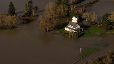A drone view shows a home surrounded by water in an area flooded by the Snoqualmie River, as an atmospheric river brings rain and flooding to the Pacific Northwest, in Fall City, Washington, U.S., December 9, 2025.  REUTERS/David Ryder (REUTERS)