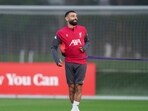 Liverpool's Mohamed Salah smiles as he takes part in a training session in Liverpool, England. (AP)
