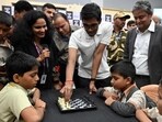 India’s chess grandmaster R Praggnanandhaa playing chess with school students at the Dharavi Sports Complex in Mumbai on Friday. (Raju Shinde/HT Photo)