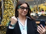WSJ's Joanna Stern, outfitted in an AI trifecta: a Bee recording bracelet, an Omi recording necklace and Ray-Ban Meta Display glasses.