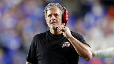 Kyle Whittingham head coach of the Utah Utes talks into his headset during the second half of their game against the Brigham Young Cougars (Getty Images via AFP) Kyle Whittingham head coach of the Utah Utes talks into his headset during the second half of their game against the Brigham Young Cougars (Getty Images via AFP)