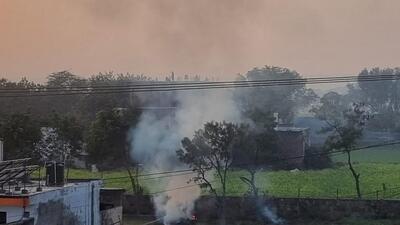 Waste burning seen on a vacant plot in Gurugram on Friday. (HT) Waste burning seen on a vacant plot in Gurugram on Friday. (HT)
