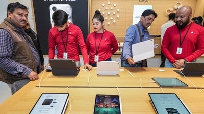 Staff members, assisting customers during the launch of Apple's new store, in Noida on Thursday. (PTI) Staff members, assisting customers during the launch of Apple's new store, in Noida on Thursday. (PTI)