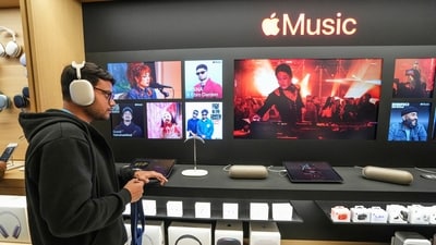 A customer checks an Apple headphone during the launch of the company's new store in Noida. (PTI) A customer checks an Apple headphone during the launch of the company's new store in Noida. (PTI)