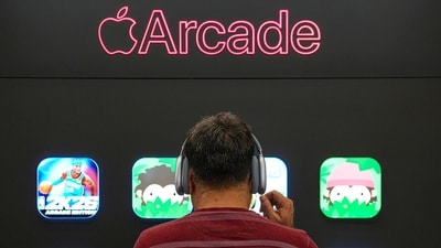 A man looks at a big screen showing different games of Apple Arcade at the company's newly launched store at DLF Mall of India, in Noida. (PTI) A man looks at a big screen showing different games of Apple Arcade at the company's newly launched store at DLF Mall of India, in Noida. (PTI)