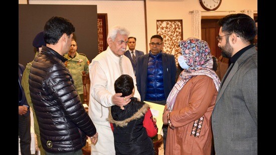 J&K LG Manoj Sinha with family of one of the victims in Nowgam on Friday. (Sourced)
