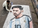 An artist paints a street graffiti of Argentina footballer Lionel Messi, in Kolkata on Friday. An artist paints a street graffiti of Argentina footballer Lionel Messi, in Kolkata on Friday.