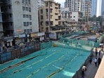 At the Elphinstone Bridge demolition site, the debris has been covered with green sheets to avoid dust particles from spreading. (Raju Shinde/HT Photo)