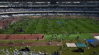 When Messi entered the stadium premises, he was surrounded by a human barricade of security. Despite multiple requests, the field could not be cleared and ultimately the 2022 FIFA World Cup winner had to be escorted out and this incident tipped the fans over the edge, resulting in chaos and vandalism. (HT Photo ) When Messi entered the stadium premises, he was surrounded by a human barricade of security. Despite multiple requests, the field could not be cleared and ultimately the 2022 FIFA World Cup winner had to be escorted out and this incident tipped the fans over the edge, resulting in chaos and vandalism. (HT Photo )