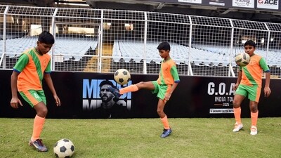 Children play football during the final presentation ahead of Football legend Lionel Messi's visit, at Salt Lake Stadium in Kolkata on Friday. (Debajyoti Chakraborty ) Children play football during the final presentation ahead of Football legend Lionel Messi's visit, at Salt Lake Stadium in Kolkata on Friday. (Debajyoti Chakraborty )