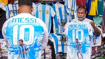 A street vendor in Kolkata sells Lionel Messi's jerseys ahead of his visit to the city as part of the 'G.O.A.T. India Tour 2025. (PTI) A street vendor in Kolkata sells Lionel Messi's jerseys ahead of his visit to the city as part of the 'G.O.A.T. India Tour 2025. (PTI)