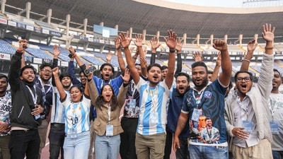 Football fans cheer on the eve of Lionel Messi's 'GOAT Tour India 2025' at the Vivekananda Yuba Bharati Krirangan stadium, in Kolkata. (PTI) Football fans cheer on the eve of Lionel Messi's 'GOAT Tour India 2025' at the Vivekananda Yuba Bharati Krirangan stadium, in Kolkata. (PTI)