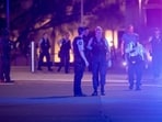 Police officers walk on the street following a shooting incident at Bondi Beach, in Sydney, Australia, December 14, 2025