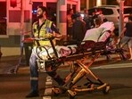 A health worker moves a stretcher after a shooting incident at Bondi Beach in Sydney on December 14, 2025. Australian police said two people were in custody following reports of multiple gunshots on December 14 at Sydney's famed Bondi Beach, urging the public to take shelter. (Photo by Saeed KHAN / AFP) A health worker moves a stretcher after a shooting incident at Bondi Beach in Sydney on December 14, 2025. Australian police said two people were in custody following reports of multiple gunshots on December 14 at Sydney's famed Bondi Beach, urging the public to take shelter. (Photo by Saeed KHAN / AFP)