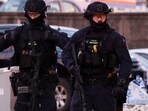 Armed police work at the scene after a shooting incident at Bondi Beach in Sydney on December 14, 2025. Australian police said two people were in custody following reports of multiple gunshots on December 14 at Sydney's famed Bondi Beach, urging the public to take shelter. Armed police work at the scene after a shooting incident at Bondi Beach in Sydney on December 14, 2025. Australian police said two people were in custody following reports of multiple gunshots on December 14 at Sydney's famed Bondi Beach, urging the public to take shelter.