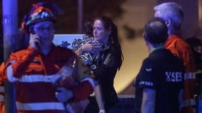 A woman holds a child in a blanket after a shooting incident at Bondi Beach in Sydney on December 14, 2025. (AFP) A woman holds a child in a blanket after a shooting incident at Bondi Beach in Sydney on December 14, 2025. (AFP)