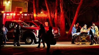 TOPSHOT - First responders with the Providence Fire Department maneuver an empty stretcher near the Barus & Holley building, home to the engineering and physics departments and the site of a mass shooting, at Brown University campus in Providence, Rhode Island, on December 13, 2025. (Photo by Bing Guan / AFP) (AFP) TOPSHOT - First responders with the Providence Fire Department maneuver an empty stretcher near the Barus & Holley building, home to the engineering and physics departments and the site of a mass shooting, at Brown University campus in Providence, Rhode Island, on December 13, 2025. (Photo by Bing Guan / AFP) (AFP)