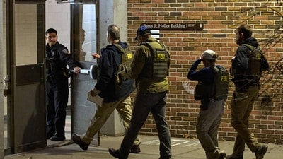 FBI agents enter the Barus & Holley building, home to the engineering and physics departments and the site of a mass shooting, at Brown University campus in Providence, Rhode Island, on December 13, 2025. (Photo by Bing Guan / AFP) (AFP) FBI agents enter the Barus & Holley building, home to the engineering and physics departments and the site of a mass shooting, at Brown University campus in Providence, Rhode Island, on December 13, 2025. (Photo by Bing Guan / AFP) (AFP)