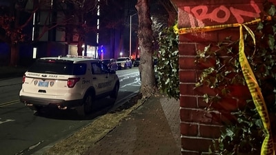 A police vehicle is parked in the street near a wall with police tape tied to it after a shooting incident at Brown University in Providence, Rhode Island, U.S., December 13, 2025. REUTERS/Stringer (REUTERS)