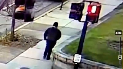 A monitor shows security camera footage of what police say is the Brown University shooting suspect walking along Hope Street after leaving the scene of shooting, in this screengrab taken from a handout video released December 13, 2025. Providence Public Information Officer/Handout via REUTERS    THIS IMAGE HAS BEEN SUPPLIED BY A THIRD PARTY. NO RESALES. NO ARCHIVES. MANDATORY CREDIT.   Verification Lines: Reuters was able to verify the location by road layout, road signs and the traffic lights match with file and satellite images. Reuters was not able to independently verify the Date. Providence Police Department stated that a shooting at Brown University caused 2 death and 9 injuries in Providence, Rhode Island on Saturday (December 13, 2025) (via REUTERS)