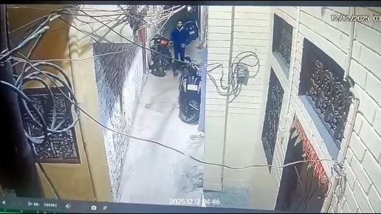 A grab from the viral CCTV footage showing thieves locking entry gates of houses (SOURCED)