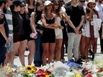 Mourners gather by floral tributes at the Bondi Pavillion in memory of the victims of a shooting at Bondi Beach, in Sydney on December 15. 